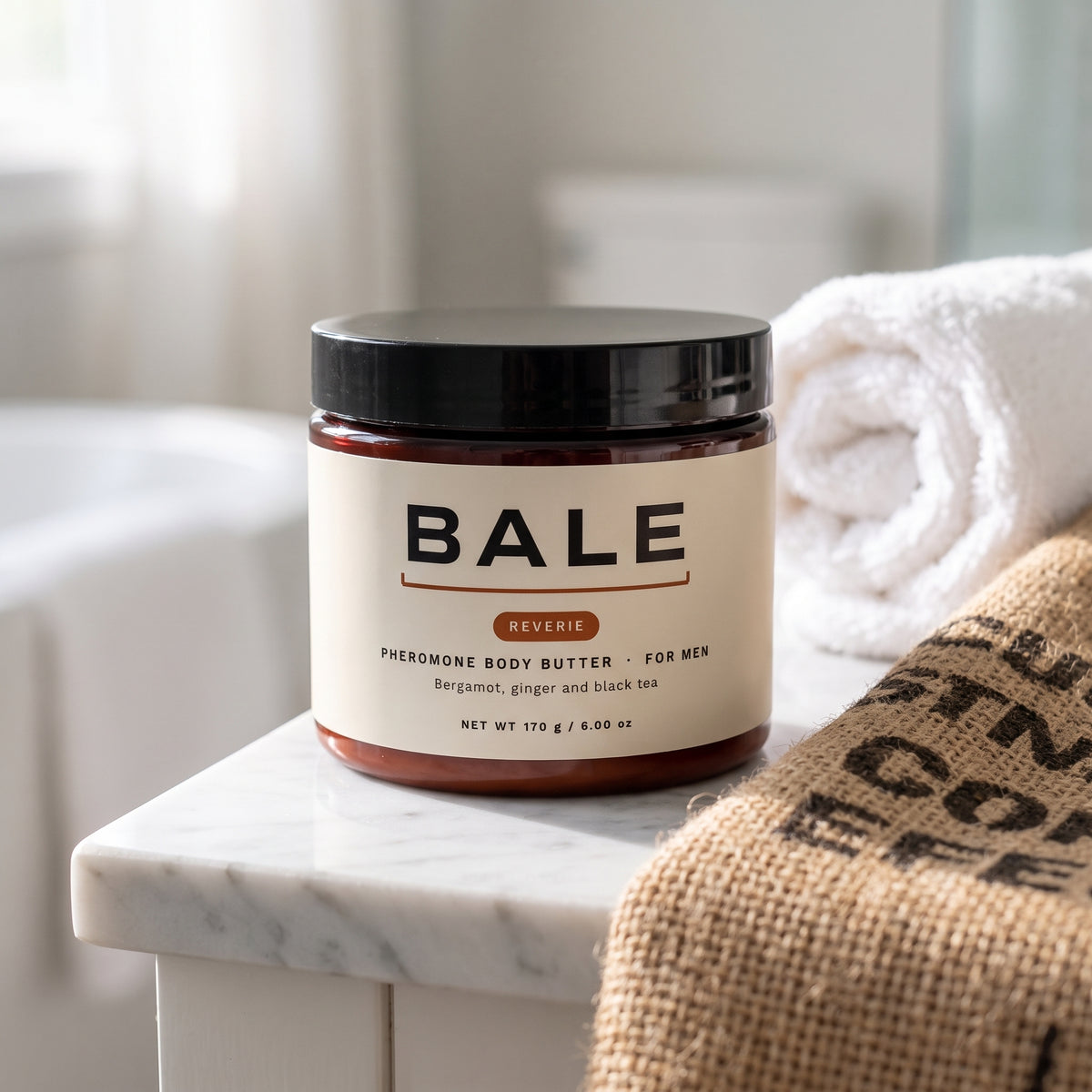 Reverie jar on a marble vanity beside a coffee sack and a towel