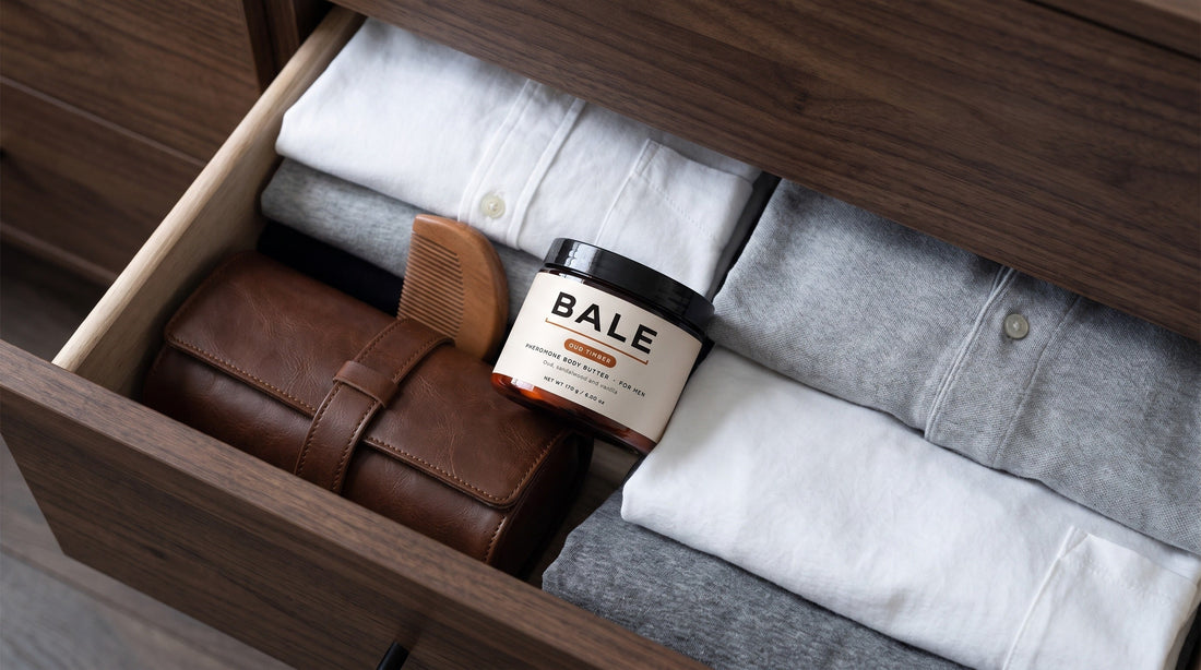 A closed Bale jar in an open dresser drawer among folded shirts and a leather watch roll