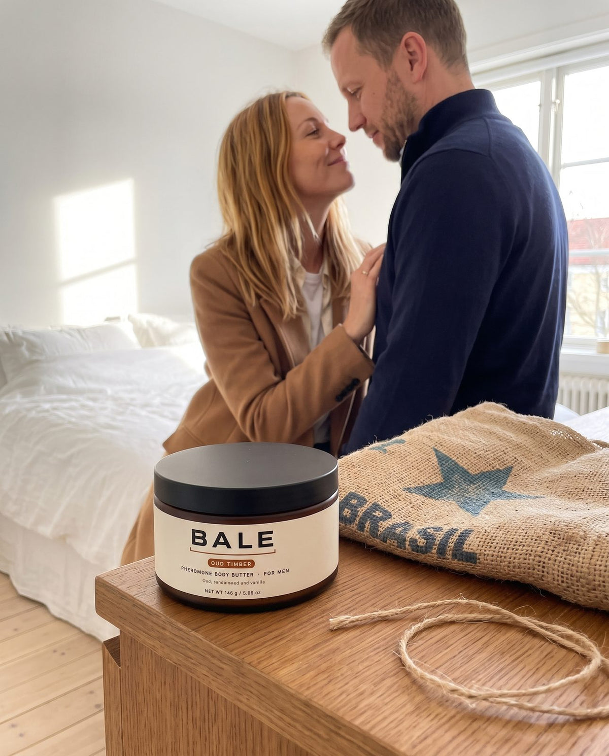 She straightens his collar before dinner, Oud Timber jar on the dresser