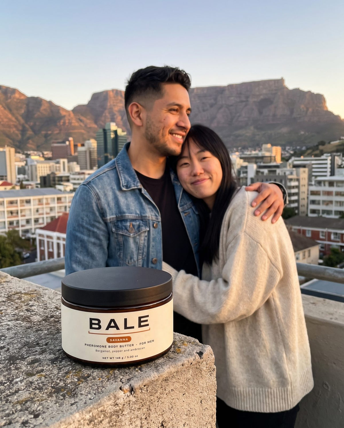 Couple on a rooftop at golden hour, Savanna jar on the ledge