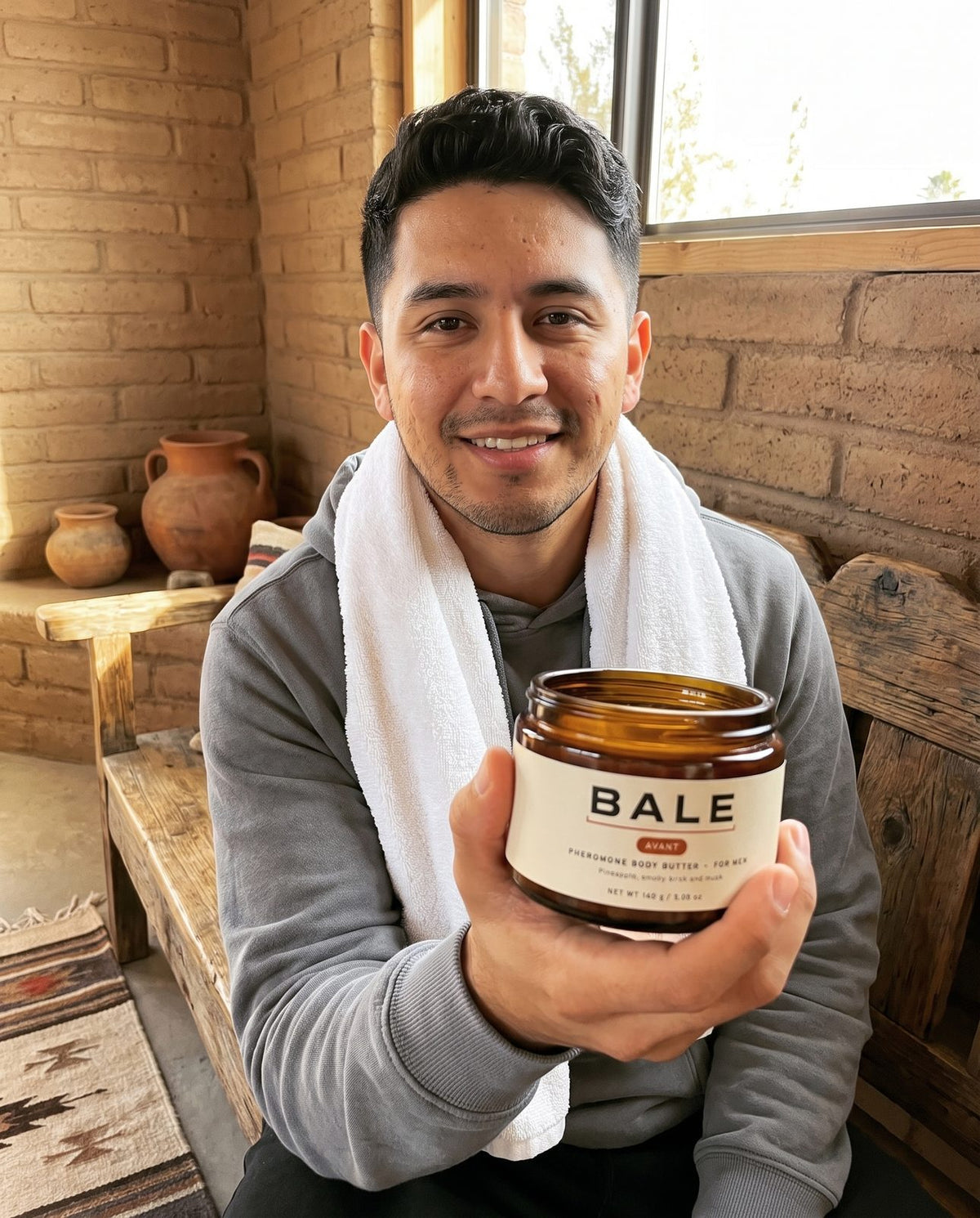 Man after the gym holding an open jar of Avant body butter